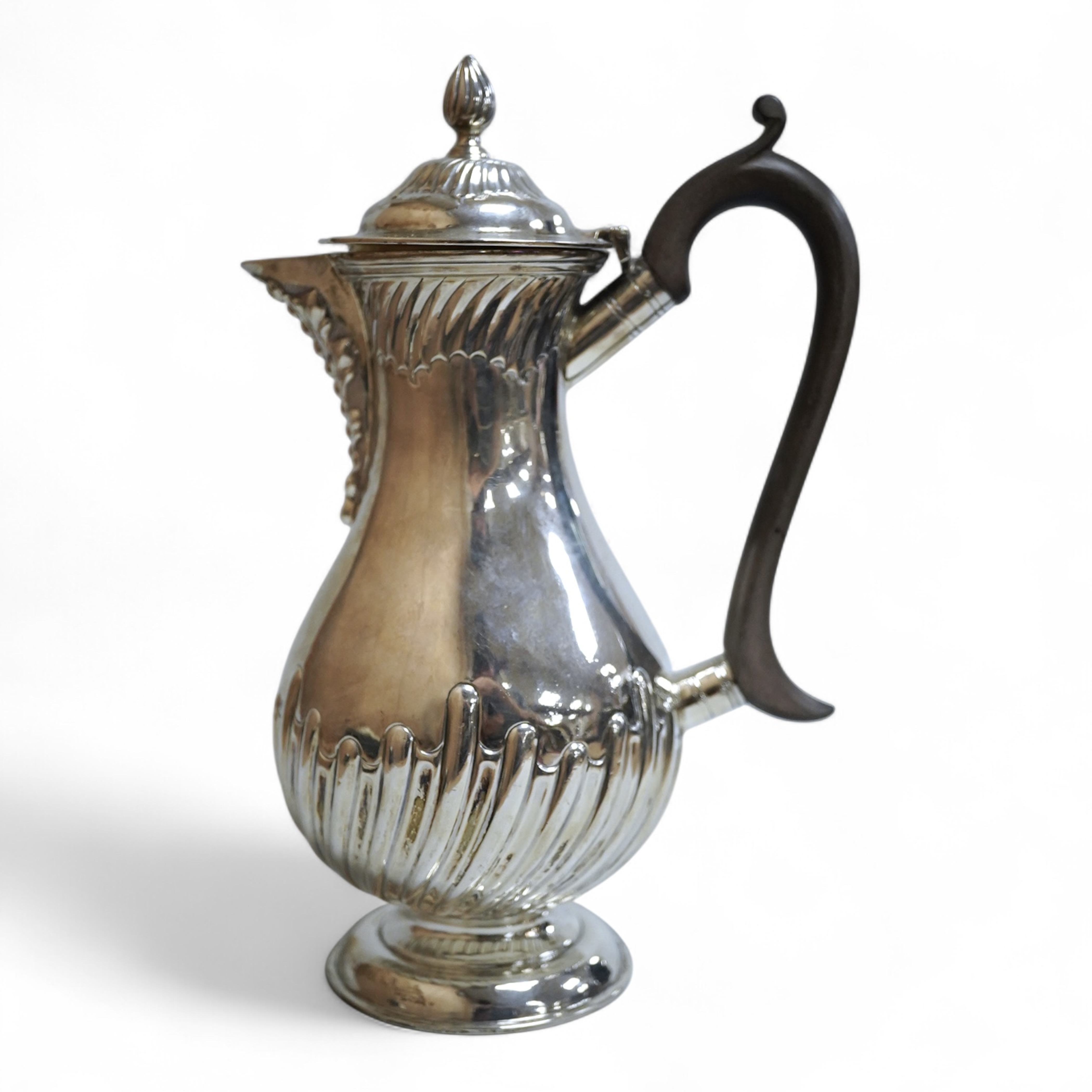 An Edwardian demi-fluted silver baluster hot water jug, William Hutton & Sons, London, 1902, height 21cm, 13.4oz.